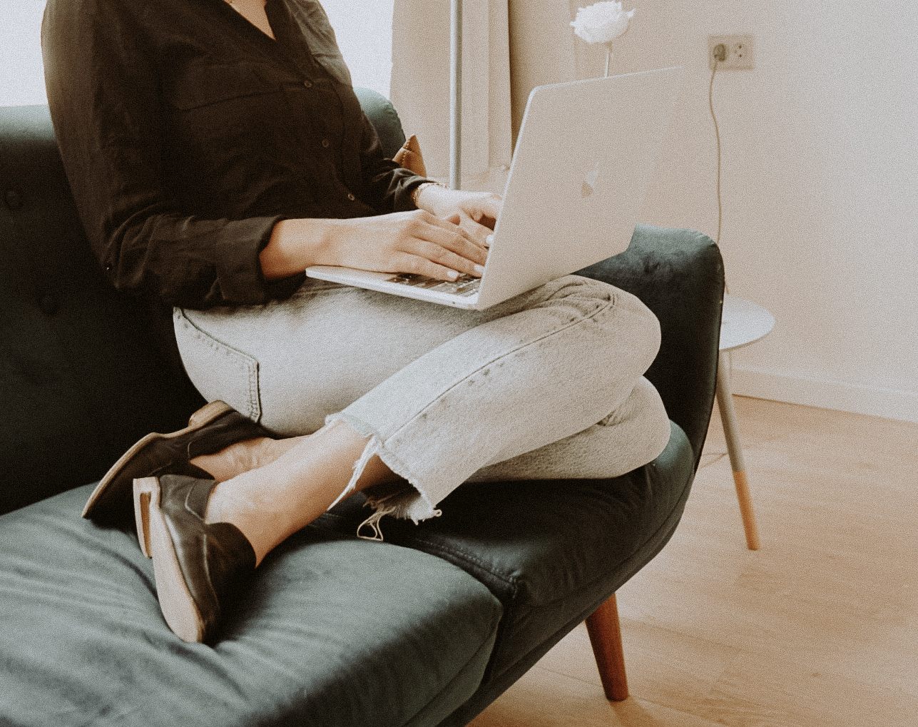 Christian woman entrepreneur working on laptop from home, focused on building her business without social media burnout.