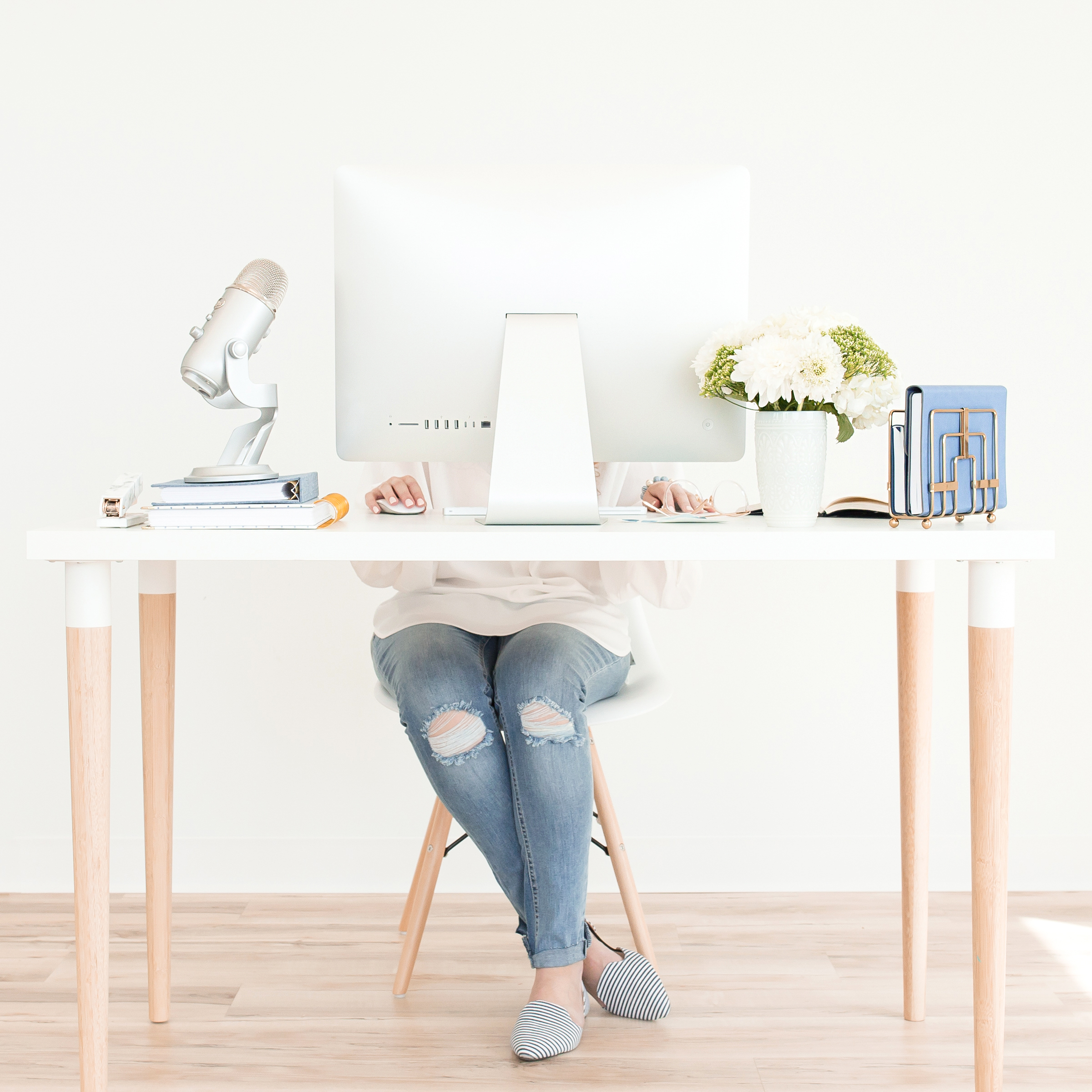 Christian woman entrepreneur working at her desk with podcast microphone — how to market your business without social media